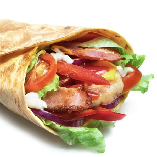 Chicken wrap with bacon, lettuce, tomato, red onion, and sauces, on a white background.