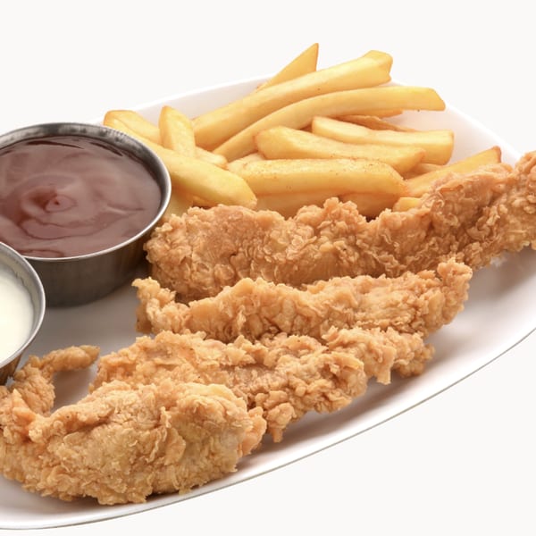 Crispy chicken tenders with golden french fries and two dipping sauces on a white plate.